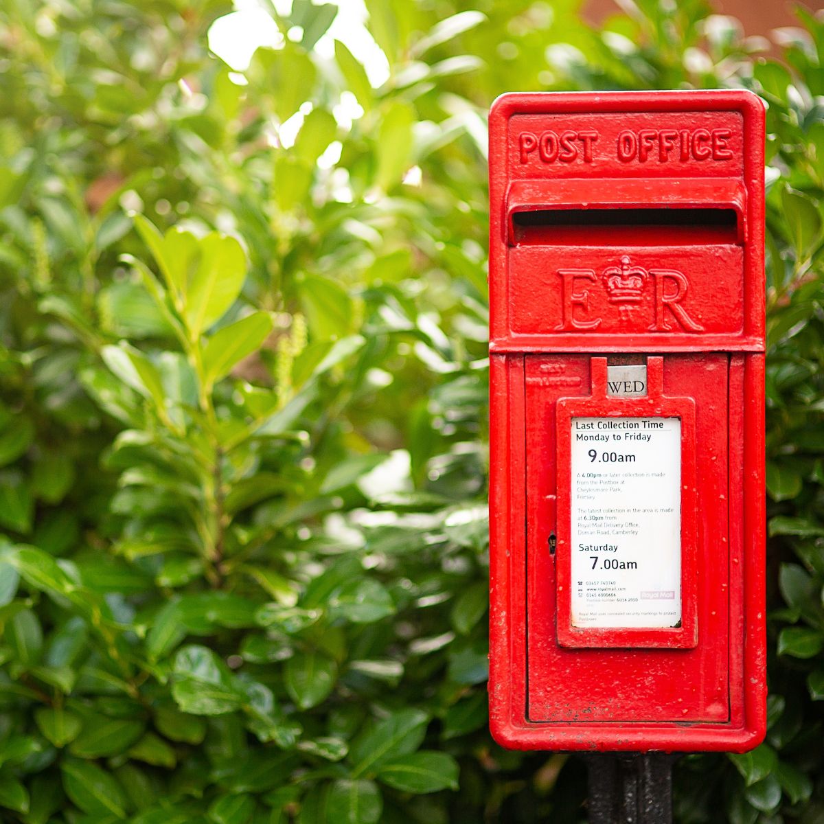 Front perspective of a Post Office mail box painted in red.