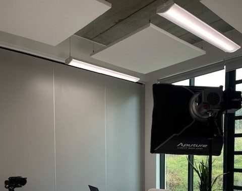 A room set up with photography equipment and lighting.