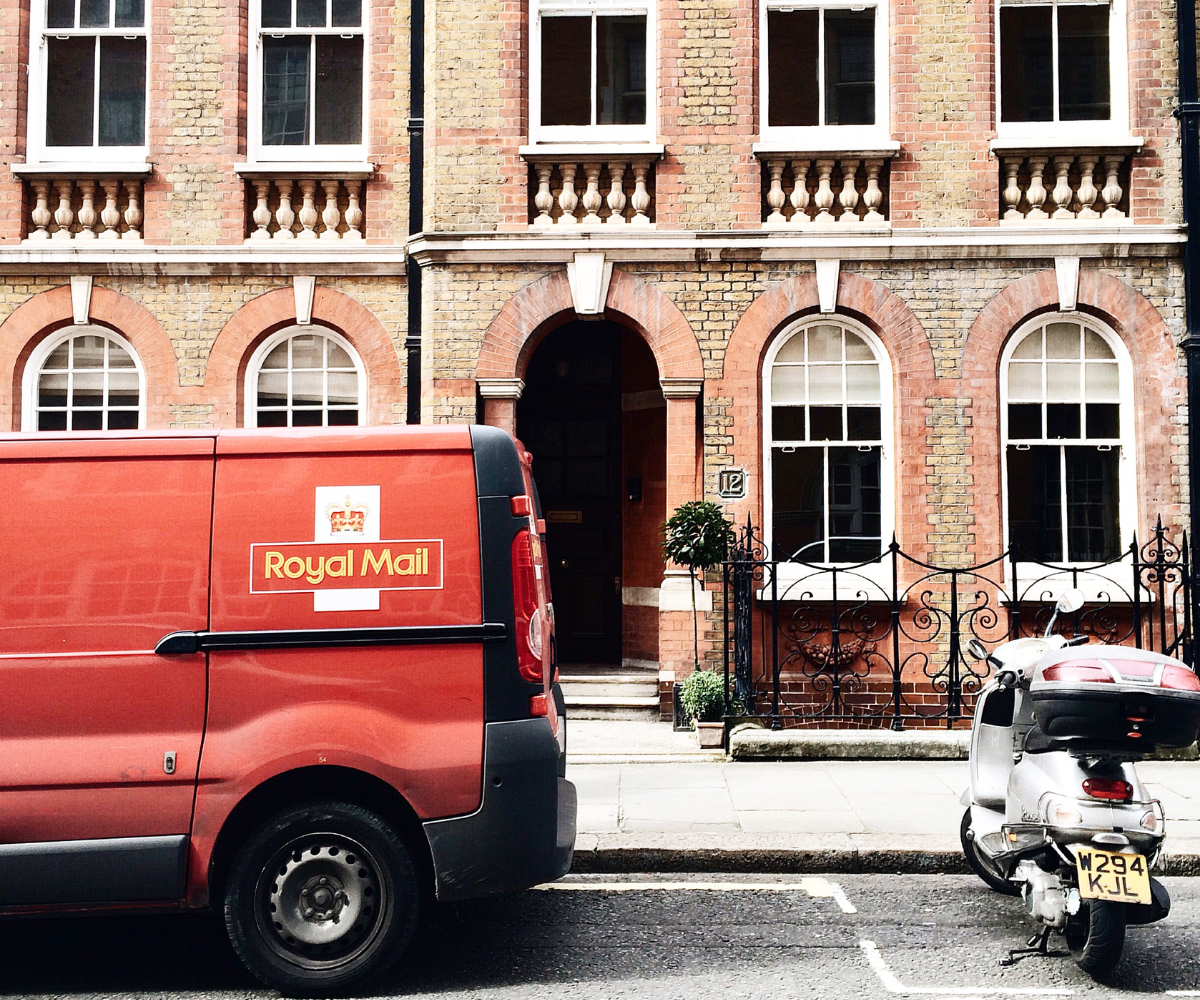 Royal Mail van parked outside a georgian style building